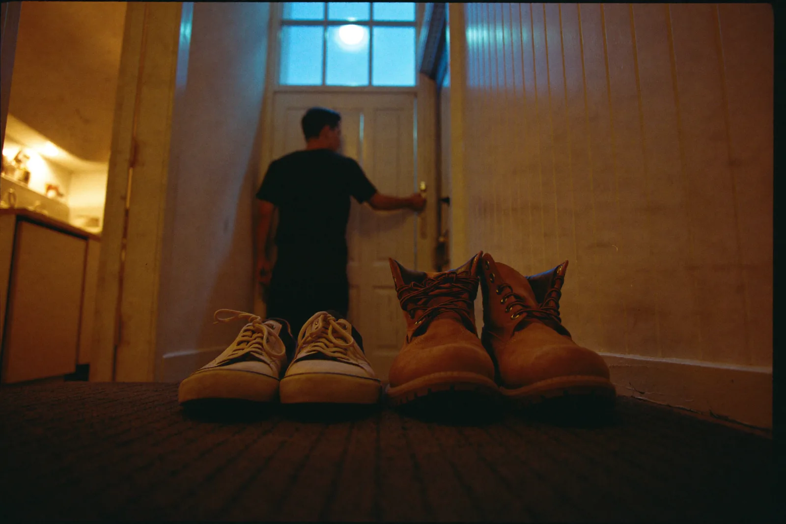 A dad checks the front door lock at night.